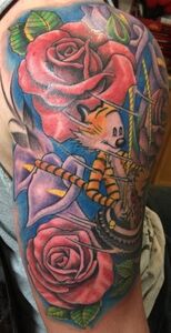 Tattoo of Calvin riding Hobbes on a swing, surrounded by red roses and purple flowers on a blue background.