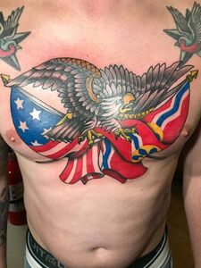 Tattoo of an eagle with outstretched wings clutching a Confederate flag. Red, white, and blue colors.