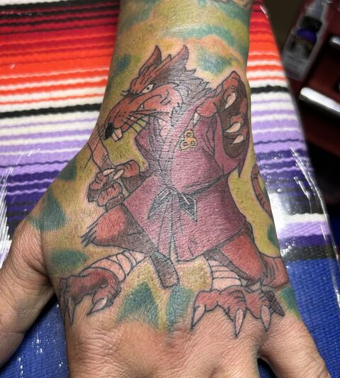 Color werewolf tattoo on the back of a hand