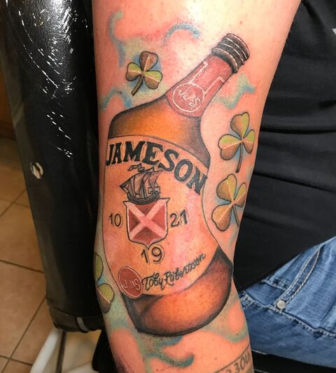 Jameson whiskey bottle and shamrock color tattoo