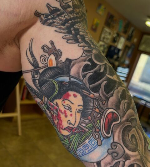 Geisha color tattoo inside a black and grey sleeve