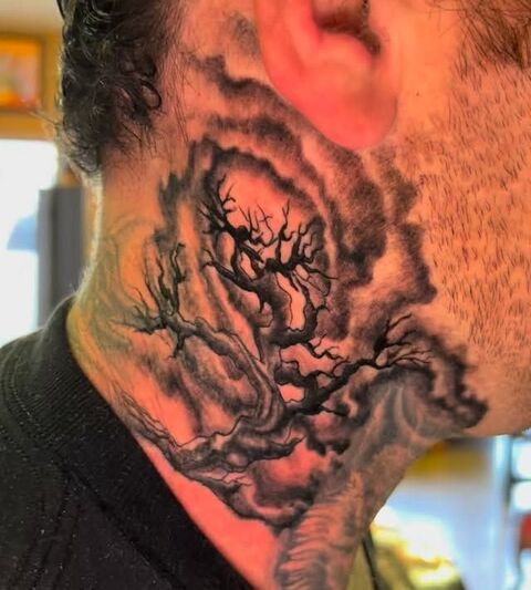 Black and grey tree and clouds neck tattoo
